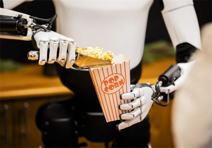 Dexterous robot hands scooping popcorn to showcase fine motor manipulation capability