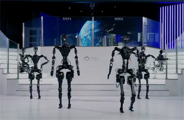 Bare mechanical skeleton humanoid robots staging coordinated walking demo on futuristic presentation stage