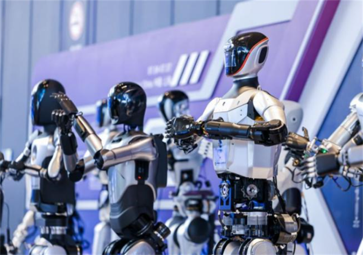 Group of polished commercial humanoid robots performing synchronized motion at tech showcase event