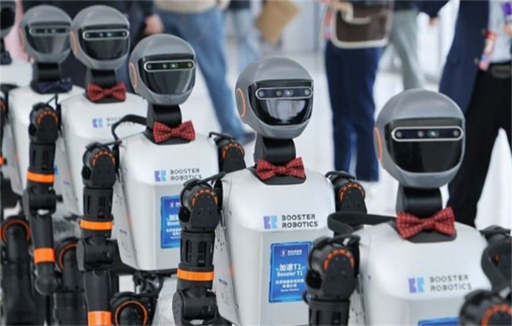 Neat row of Booster Robotics humanoid service robots fitted with formal red bow ties at industry exhibition