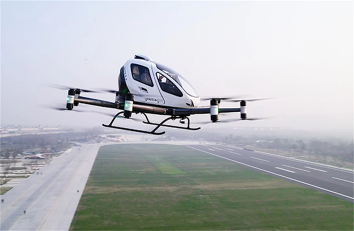 Electric eVTOL passenger air taxi hovering above airport runway for low-altitude urban air mobility