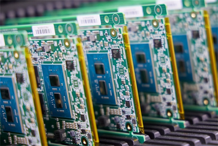 Row of AI chips on circuit boards in production