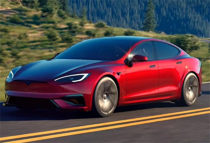 Red Tesla Model S luxury electric sedan driving along mountain roadside highway