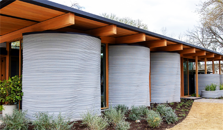 Finished modern single-family house featuring textured layered 3D-printed concrete curved exterior columns and wooden roof framing